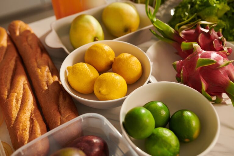 Bowls with fresh limes, lemon and passion fruits on kitchen table